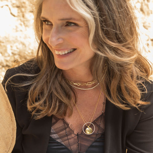 play on her angular themes by pairing with<br>shop the look > feeling golden limited edition half moon with starburst diamond earrings on diamond faced huggie hoops, in 18k rose gold <span class='visuallyhidden'>Text, phone 323-404-2959 for shopping help.</span>